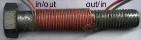 A pair of wires wrapped around a nail